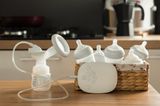 Photo of a breast pump and basket full of bottles