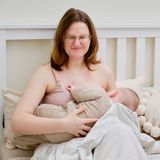 Woman breastfeeding with a pained look on her face